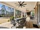 Covered brick patio featuring ceiling fans, outdoor seating, fireplace, and beautiful views of the landscaped yard at 3669 High Green Dr, Marietta, GA 30068