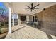 Inviting covered patio with brick flooring, cozy fireplace, rocking chairs, and views of the serene backyard at 3669 High Green Dr, Marietta, GA 30068