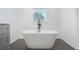 Contemporary bathroom showcasing a freestanding tub, tiled floors, and neutral-toned walls at 8671 Lake Forrest Dr, Douglasville, GA 30134