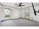 Bright bedroom featuring hardwood floors, neutral walls, and large windows at 8671 Lake Forrest Dr, Douglasville, GA 30134