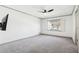 Spacious carpeted bedroom with a window, ceiling fan, and neutral-toned walls at 8671 Lake Forrest Dr, Douglasville, GA 30134