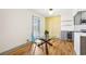 Cozy dining area with glass table and a view into the modern kitchen at 8671 Lake Forrest Dr, Douglasville, GA 30134