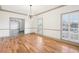 Bright dining room featuring hardwood floors, stylish chandelier, and large shuttered windows at 8671 Lake Forrest Dr, Douglasville, GA 30134