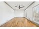 Bright room with hardwood floors, shuttered windows, grey trim and ceiling fan at 8671 Lake Forrest Dr, Douglasville, GA 30134
