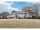 Charming single-story home with a well-manicured lawn and classic architectural details at 8671 Lake Forrest Dr, Douglasville, GA 30134