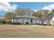 Well-maintained single-story home with manicured landscaping and a welcoming facade at 8671 Lake Forrest Dr, Douglasville, GA 30134