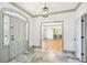 Inviting foyer with marble floors, modern chandelier, and views into other rooms at 8671 Lake Forrest Dr, Douglasville, GA 30134