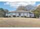 Stunning one story home featuring a symmetrical design, manicured landscaping, and a welcoming entrance at 8671 Lake Forrest Dr, Douglasville, GA 30134