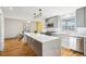 Updated kitchen featuring a large island, stainless appliances, and stylish lighting at 8671 Lake Forrest Dr, Douglasville, GA 30134