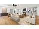 Spacious living room featuring hardwood floors, fireplace, built-in shelving and ample seating at 8671 Lake Forrest Dr, Douglasville, GA 30134