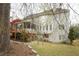 Exterior view of the home's backyard showcasing a large deck and mature trees around the property at 1191 Crofton Landing, Suwanee, GA 30024