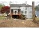 The backyard features a deck and screened in porch with mature trees around the property at 1191 Crofton Landing, Suwanee, GA 30024
