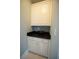 Attractive white cabinet with black countertop offering practical and beautiful storage solution at 1191 Crofton Landing, Suwanee, GA 30024