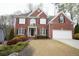 Charming two-story brick home with well-manicured landscaping, and an attached two car garage at 1191 Crofton Landing, Suwanee, GA 30024