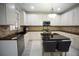 Bright kitchen featuring granite countertops, stainless steel appliances, and a kitchen island with seating at 1191 Crofton Landing, Suwanee, GA 30024