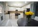 Bright kitchen featuring granite countertops, stainless steel appliances, and a kitchen island with seating at 1191 Crofton Landing, Suwanee, GA 30024