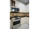 Stainless steel oven range with stainless steel microwave above and backsplash at 1191 Crofton Landing, Suwanee, GA 30024