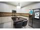 Kitchen featuring granite countertops, stainless steel appliances, and a kitchen island with seating at 1191 Crofton Landing, Suwanee, GA 30024