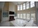 Bright living room featuring a fireplace, built-in shelves, and large windows at 1191 Crofton Landing, Suwanee, GA 30024