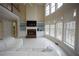 Bright living room featuring a fireplace, built-in shelves, and large windows at 1191 Crofton Landing, Suwanee, GA 30024
