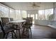Spacious screened porch with table and chairs and a hanging swing at 1191 Crofton Landing, Suwanee, GA 30024