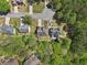 Aerial view shows homes with well-kept lawns and green space in a suburban setting at 1191 Crofton Lndg, Suwanee, GA 30024