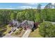 Beautiful aerial view of the brick home with mature trees in a suburban neighborhood at 1191 Crofton Lndg, Suwanee, GA 30024