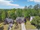 Scenic aerial shot of the two-story home surrounded by lush greenery and neighboring houses at 1191 Crofton Lndg, Suwanee, GA 30024