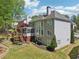 Backyard with a deck, screened porch, retaining wall, and lawn at 1191 Crofton Lndg, Suwanee, GA 30024