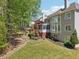 Spacious backyard with a deck, porch, retaining wall, and lawn at 1191 Crofton Lndg, Suwanee, GA 30024