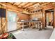 Unfinished basement space with workbench and walkout to the yard at 1191 Crofton Lndg, Suwanee, GA 30024