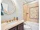 Well-maintained bathroom featuring a vanity with marble countertop and shower-tub combo with decorative tile at 1191 Crofton Lndg, Suwanee, GA 30024