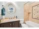 Well-maintained bathroom featuring a vanity with marble countertop and shower-tub combo with decorative tile at 1191 Crofton Lndg, Suwanee, GA 30024
