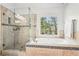 Inviting bathroom with soaking tub, frameless glass shower and natural light at 1191 Crofton Lndg, Suwanee, GA 30024