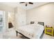 Bright bedroom featuring neutral walls, tiled floor, a large window, and a simple bed frame at 1191 Crofton Lndg, Suwanee, GA 30024