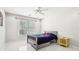 Neutral bedroom with white tile floors, window, and a ceiling fan at 1191 Crofton Lndg, Suwanee, GA 30024