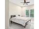 Bright bedroom featuring neutral walls, tiled floor, a large window, and a simple bed frame at 1191 Crofton Lndg, Suwanee, GA 30024