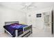 Neutrally painted bedroom with white tile floors, ceiling fan, and closet at 1191 Crofton Lndg, Suwanee, GA 30024