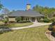 Inviting Lansmoore Clubhouse with a well-maintained lawn and lush landscaping on a sunny day at 1191 Crofton Lndg, Suwanee, GA 30024