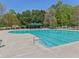 Relaxing pool view with lounge chairs, shade, and a stunning backdrop of mature trees at 1191 Crofton Lndg, Suwanee, GA 30024