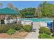Community pool area with covered seating, surrounded by well-manicured greenery and a safety fence at 1191 Crofton Lndg, Suwanee, GA 30024