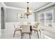 Elegant dining room featuring a modern chandelier, a round glass table, and bright natural light at 1191 Crofton Lndg, Suwanee, GA 30024