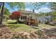Beautiful home with backyard deck, mature trees, and lush green grass at 1191 Crofton Lndg, Suwanee, GA 30024