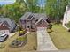 A brick two-story home with a landscaped front yard and concrete driveway at 1191 Crofton Lndg, Suwanee, GA 30024