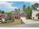 Charming two-story brick home with manicured front lawn, mature trees, and a two-car garage at 1191 Crofton Lndg, Suwanee, GA 30024