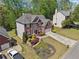 Aerial view of a brick two-story home with a well-manicured landscaped front yard at 1191 Crofton Lndg, Suwanee, GA 30024