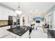 Spacious open-concept kitchen with granite countertops, island, stainless steel appliances and a view of the living room at 1191 Crofton Lndg, Suwanee, GA 30024