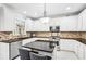 Bright kitchen featuring granite countertops, a center island, and stainless steel appliances at 1191 Crofton Lndg, Suwanee, GA 30024