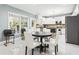 Eat-in kitchen features tile floors, stainless appliances, and access to outdoor living at 1191 Crofton Lndg, Suwanee, GA 30024