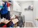 Efficient laundry room with stainless steel appliances, overhead cabinets and storage space at 1191 Crofton Lndg, Suwanee, GA 30024